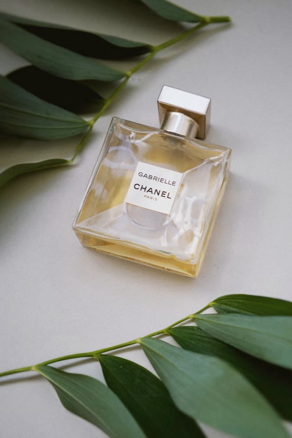 picture of gabrielle chanel perfume in between leaves